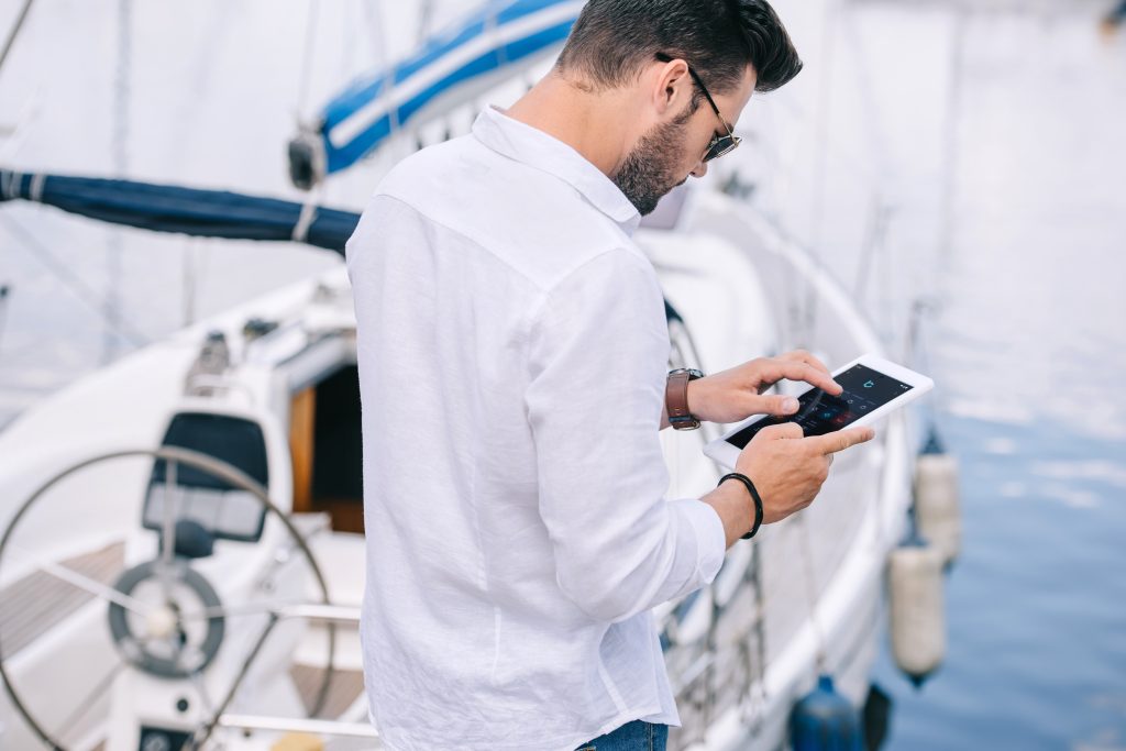 Man using cruzo app in his boat on his tablet